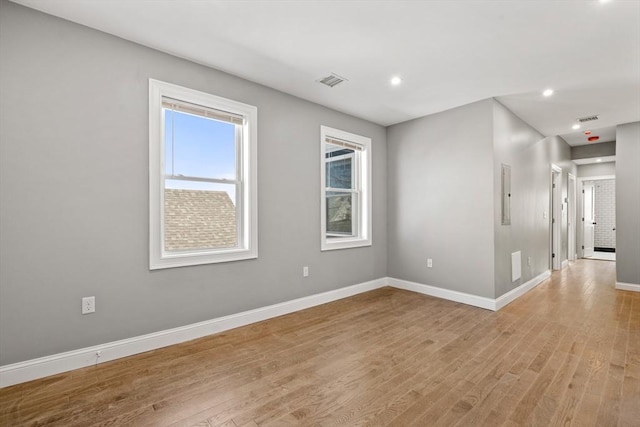 empty room with baseboards, light wood-style floors, and recessed lighting