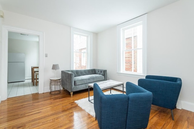 living area with wood finished floors and baseboards