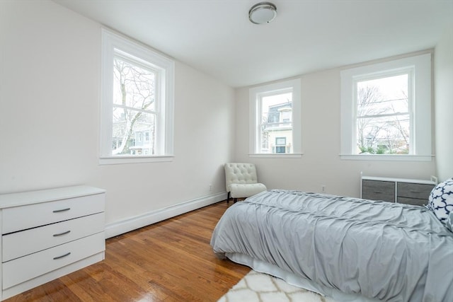 bedroom with wood finished floors and baseboards