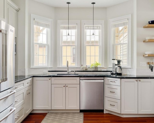 17 Rockview St Unit 1, Boston, MA 02130 - kitchen featuring appliances with stainless steel finishes, a sink, open shelves, hanging light fixtures, and white cabinets