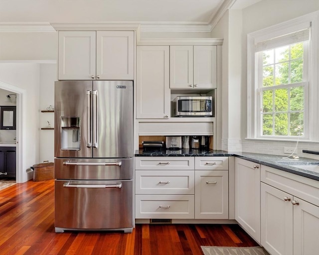 17 Rockview St Unit 1, Boston, MA 02130 - kitchen featuring stainless steel appliances, crown molding, dark wood-type flooring, dark stone countertops, and white cabinets