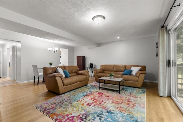 1702 Lewis O Gray Dr Unit 1702, Saugus, MA 01906 - living room with light wood-style flooring, plenty of natural light, a chandelier, recessed lighting, and a textured ceiling
