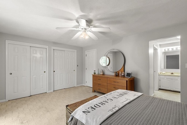 1702 Lewis O Gray Dr Unit 1702, Saugus, MA 01906 - bedroom featuring multiple closets, light carpet, ensuite bath, and a ceiling fan