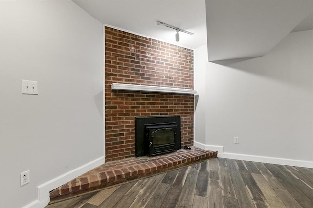 1702 Lewis O Gray Dr Unit 1702, Saugus, MA 01906 - unfurnished living room featuring rail lighting, wood finished floors, and a brick fireplace