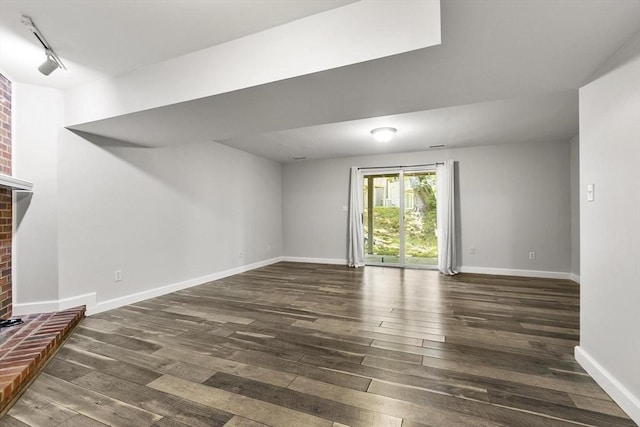 1702 Lewis O Gray Dr Unit 1702, Saugus, MA 01906 - unfurnished living room featuring hardwood / wood-style flooring, a brick fireplace, and rail lighting