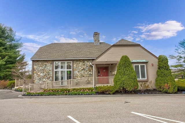 1702 Lewis O Gray Dr Unit 1702, Saugus, MA 01906 - view of front of property featuring stone siding, uncovered parking, a chimney, and covered porch