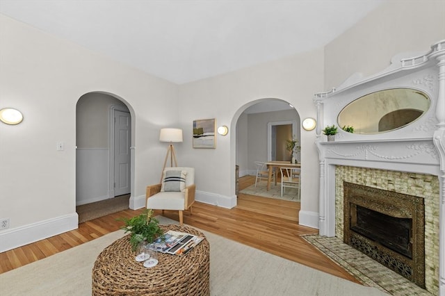 85 Holworthy Unit 85, Cambridge, MA 02138 - living area featuring wood finished floors, arched walkways, and a tile fireplace