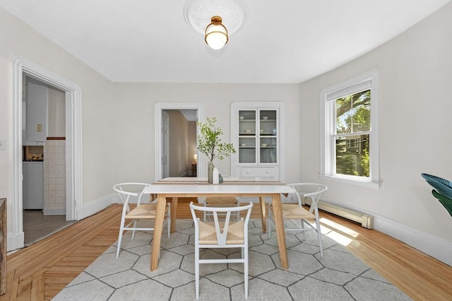 85 Holworthy Unit 85, Cambridge, MA 02138 - dining space featuring a baseboard radiator and light wood-style floors
