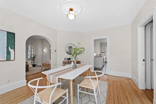 85 Holworthy Unit 85, Cambridge, MA 02138 - dining space with light wood-style flooring and arched walkways