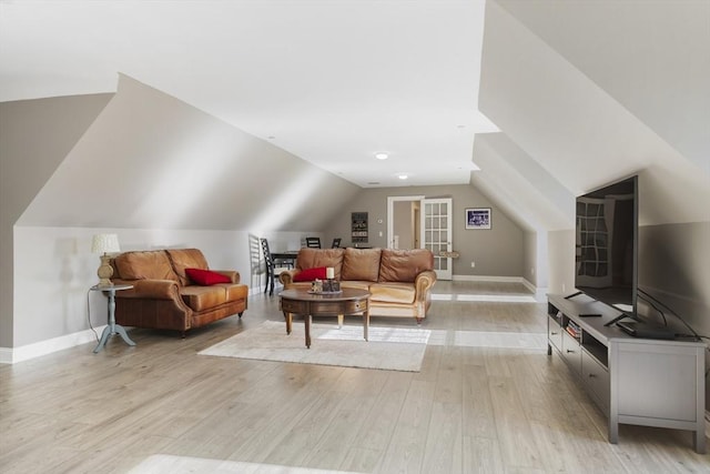 living room with light hardwood / wood-style flooring and lofted ceiling