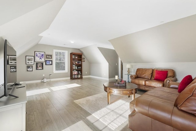 living room with vaulted ceiling and light hardwood / wood-style flooring