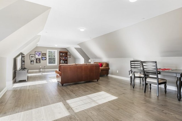 bonus room with light hardwood / wood-style flooring and lofted ceiling