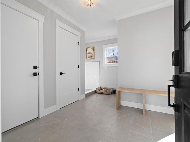 tiled foyer entrance with crown molding