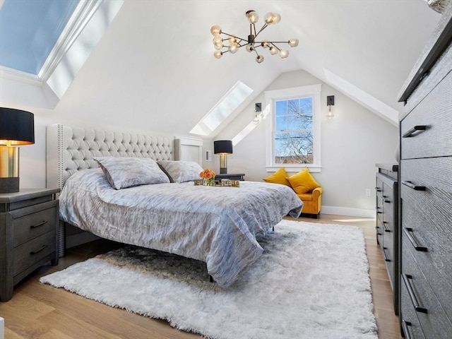 bedroom with vaulted ceiling and light hardwood / wood-style floors