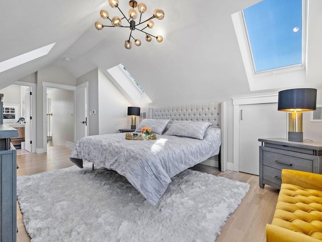 bedroom featuring vaulted ceiling with skylight, a chandelier, and light hardwood / wood-style flooring