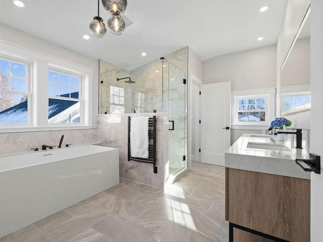 bathroom with vanity and separate shower and tub