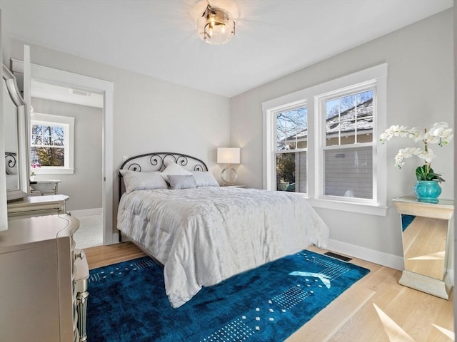 bedroom with hardwood / wood-style floors