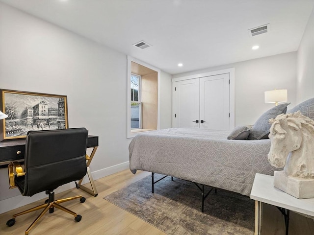 bedroom featuring light hardwood / wood-style flooring and a closet