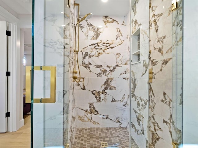 bathroom featuring hardwood / wood-style flooring and a shower with door