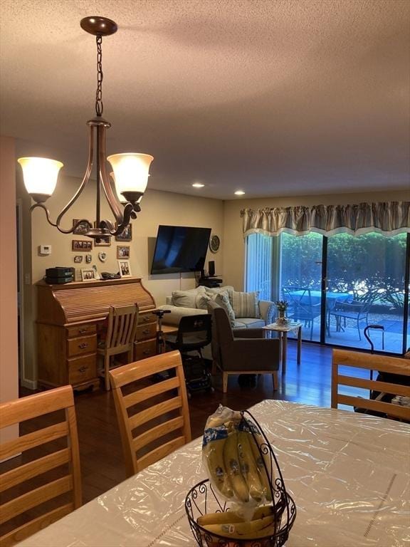 2 Summit Dr Unit 18, Reading, MA 01867 - dining area featuring wood finished floors, a textured ceiling, and a chandelier