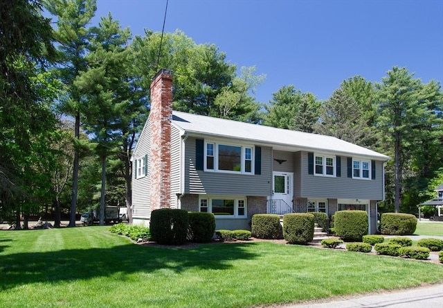 4 Morningside Dr, Beverly, MA 01915 - raised ranch featuring a chimney, a front lawn, and brick siding
