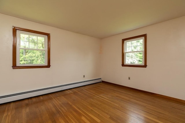 4 Morningside Dr, Beverly, MA 01915 - unfurnished room featuring baseboard heating, healthy amount of natural light, and hardwood / wood-style floors