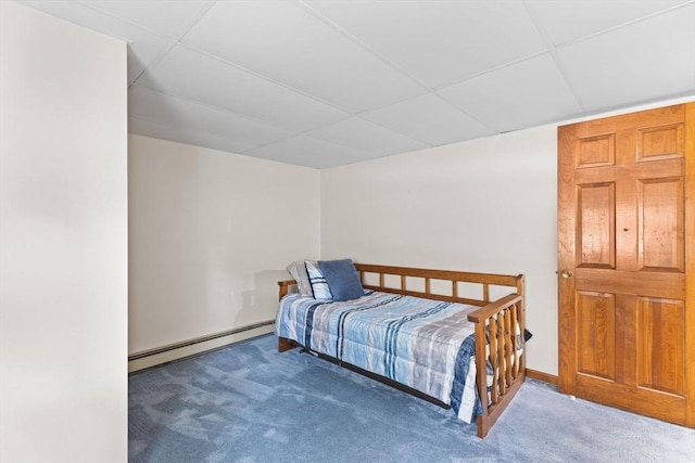 carpeted bedroom featuring a paneled ceiling and baseboard heating