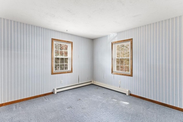 unfurnished room featuring a textured ceiling, carpet floors, baseboards, and wallpapered walls