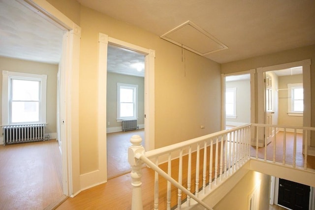 20-22 Ashland Ave, Methuen, MA 01844 - corridor with radiator heating unit, attic access, an upstairs landing, and wood finished floors