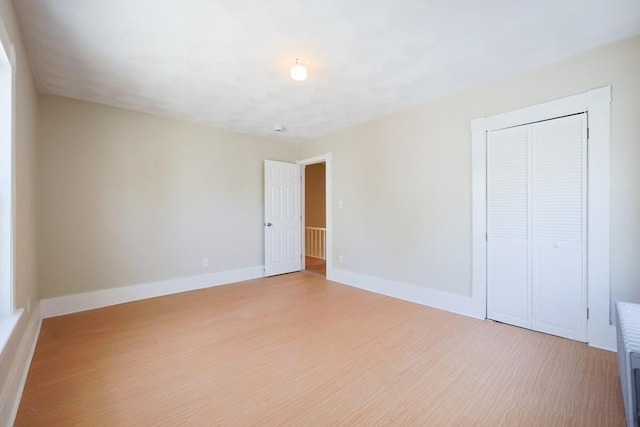 20-22 Ashland Ave, Methuen, MA 01844 - unfurnished bedroom featuring light wood-style floors, a closet, and baseboards