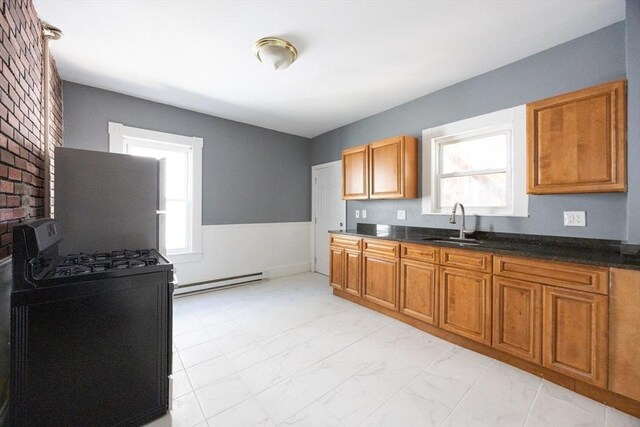 20-22 Ashland Ave, Methuen, MA 01844 - kitchen featuring range with gas stovetop, a baseboard heating unit, a sink, and healthy amount of natural light