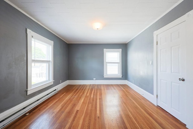 20-22 Ashland Ave, Methuen, MA 01844 - spare room with a baseboard heating unit, plenty of natural light, light wood-type flooring, crown molding, and baseboards