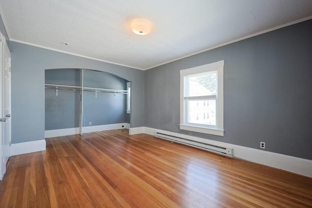 20-22 Ashland Ave, Methuen, MA 01844 - unfurnished bedroom featuring baseboard heating, ornamental molding, wood finished floors, a closet, and baseboards