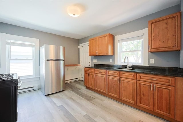 20-22 Ashland Ave, Methuen, MA 01844 - kitchen featuring freestanding refrigerator, a sink, baseboard heating, light wood-style flooring, and brown cabinets
