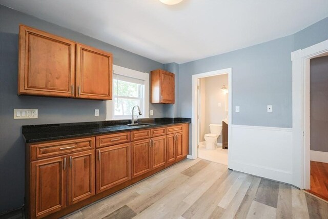 20-22 Ashland Ave, Methuen, MA 01844 - kitchen featuring a sink, light wood finished floors, brown cabinetry, and baseboards