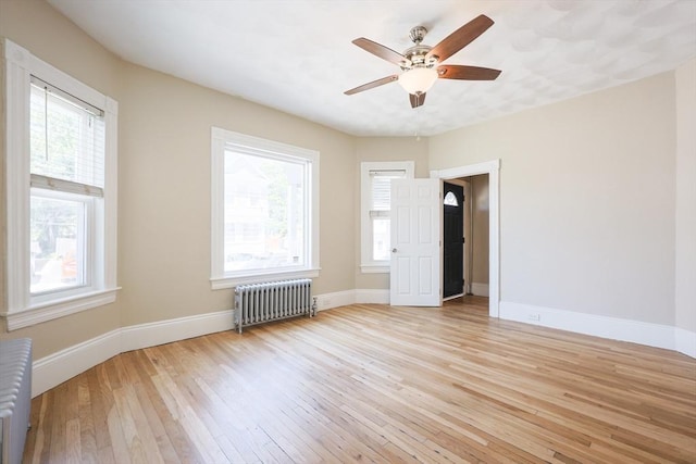 20-22 Ashland Ave, Methuen, MA 01844 - empty room featuring radiator heating unit, light wood-style flooring, baseboards, and a ceiling fan
