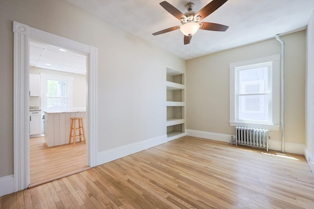 20-22 Ashland Ave, Methuen, MA 01844 - spare room with radiator heating unit, built in shelves, light wood-style flooring, and baseboards