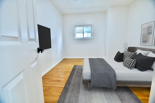 bedroom with hardwood / wood-style floors