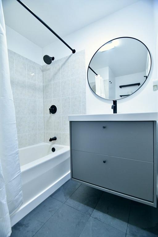 bathroom featuring tile patterned floors, vanity, and shower / bath combo