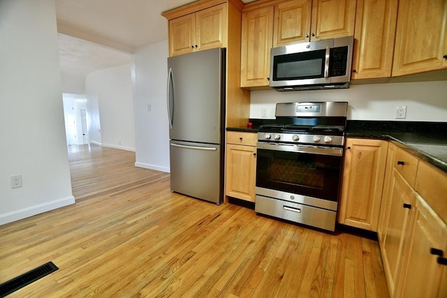 kitchen featuring stainless steel appliances and light hardwood / wood-style flooring