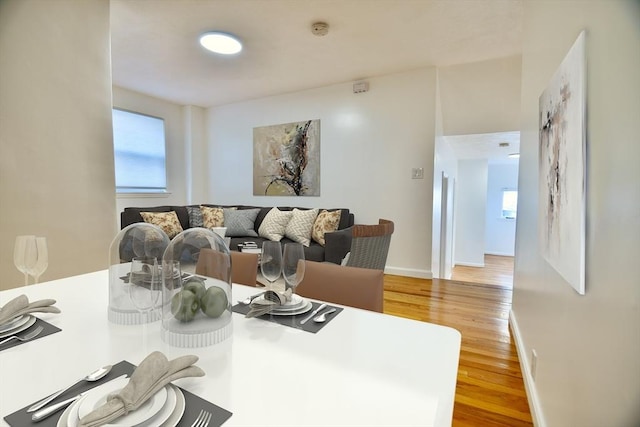 dining space featuring wood-type flooring