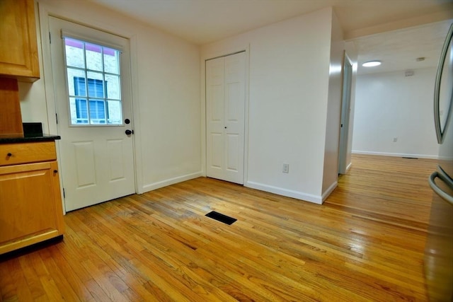 entryway with light hardwood / wood-style flooring