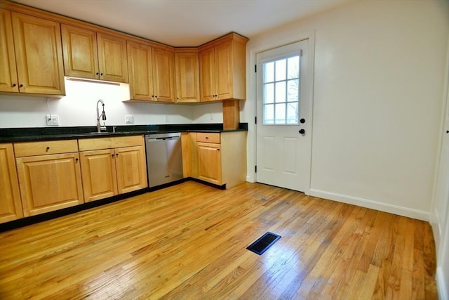 kitchen featuring stainless steel dishwasher, sink, and light hardwood / wood-style flooring