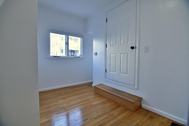 empty room with light hardwood / wood-style floors