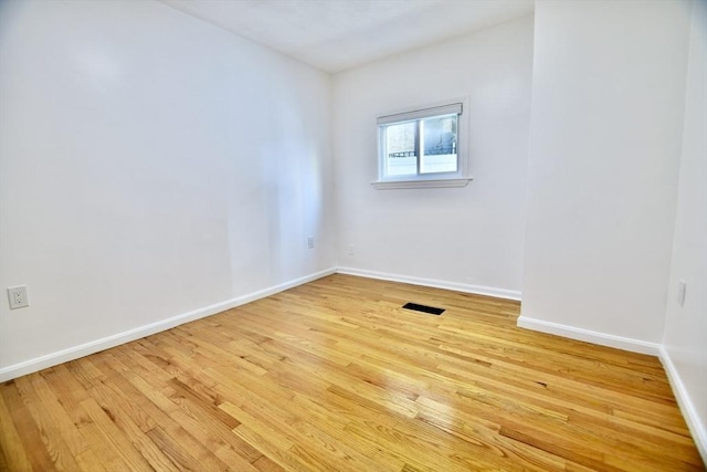 unfurnished room with light hardwood / wood-style floors