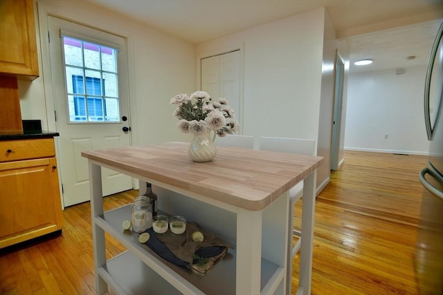 dining space featuring light wood-type flooring