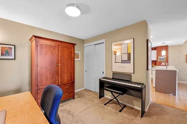 home office featuring light colored carpet and baseboards