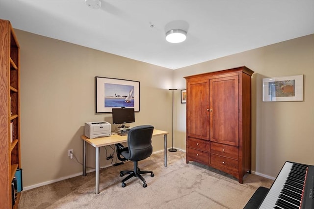 office area with light carpet and baseboards