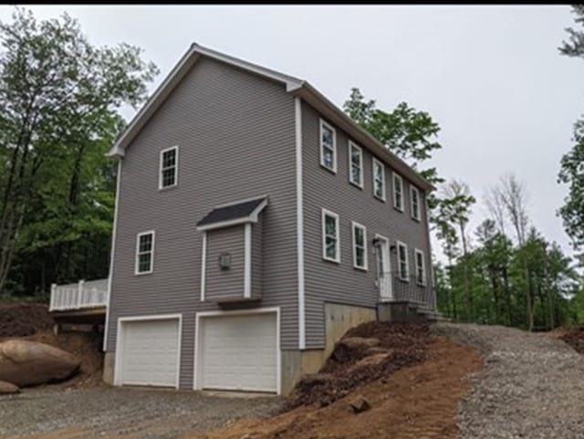 view of side of home featuring a garage