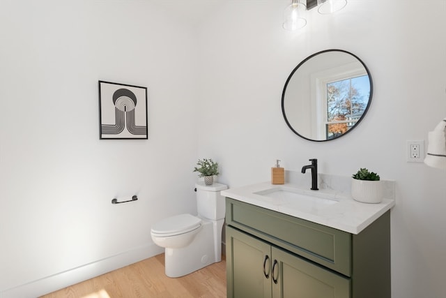 bathroom with vanity, hardwood / wood-style floors, and toilet